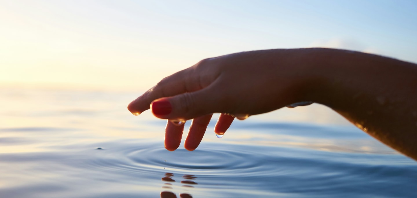 Person's hand in the sea